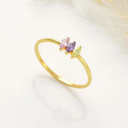 14k Gold-filled marquise birthstone ring with colorful gemstones on a light background